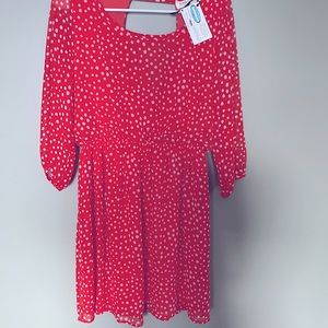 New boutique summer/ fall dress in an orange color  with white polka dots.